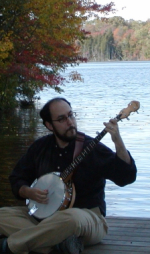 Ben Collins-Sussman playing the banjo by the water.